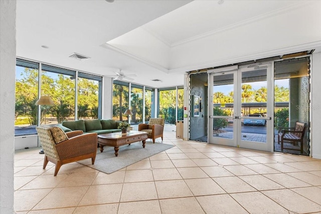 sunroom / solarium featuring ceiling fan, french doors, and a healthy amount of sunlight