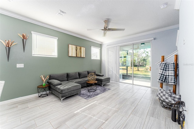 living room featuring crown molding, ceiling fan, and a textured ceiling