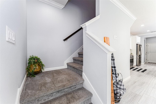 staircase featuring crown molding