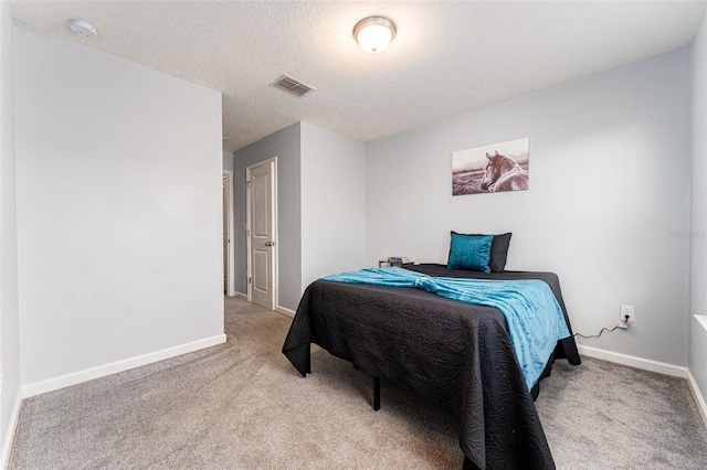 carpeted bedroom with a textured ceiling