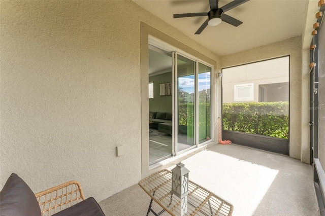 sunroom featuring ceiling fan