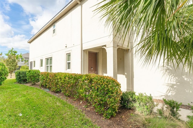 view of property exterior with a yard