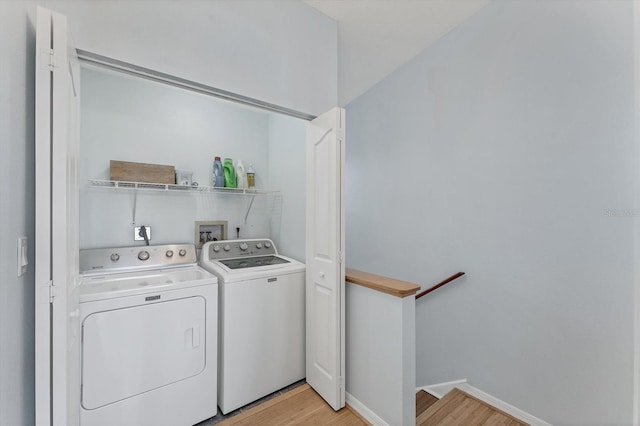 laundry room featuring light hardwood / wood-style floors and separate washer and dryer