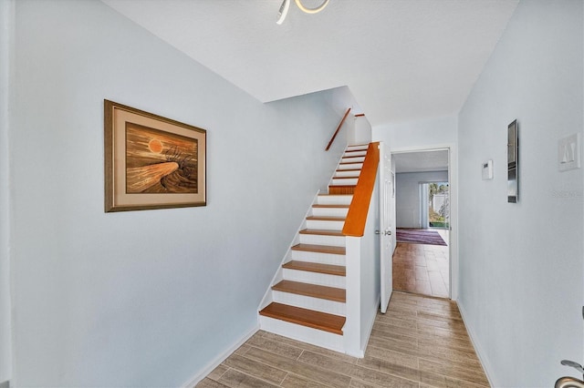 staircase featuring hardwood / wood-style floors