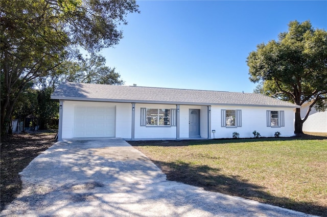 single story home featuring a garage and a front lawn