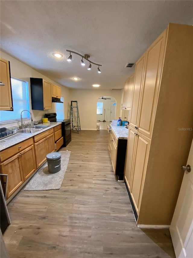 kitchen with a textured ceiling, sink, light hardwood / wood-style flooring, and black electric range