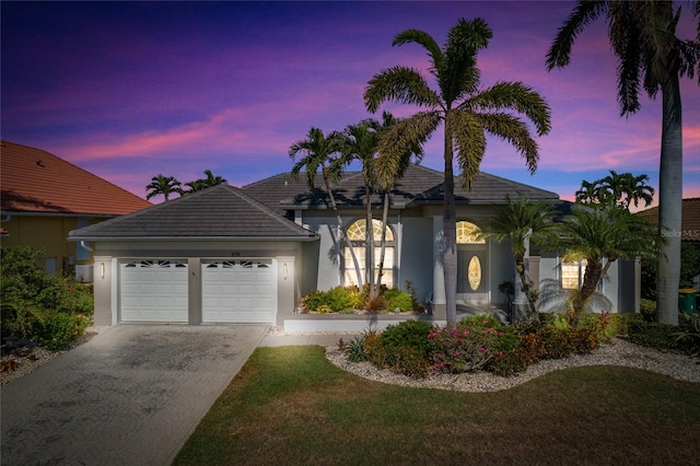 view of front of house with a lawn and a garage