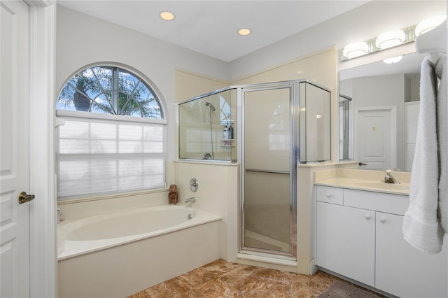 bathroom featuring vanity and separate shower and tub