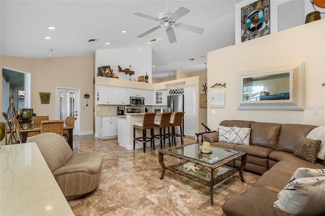 living room featuring high vaulted ceiling and ceiling fan