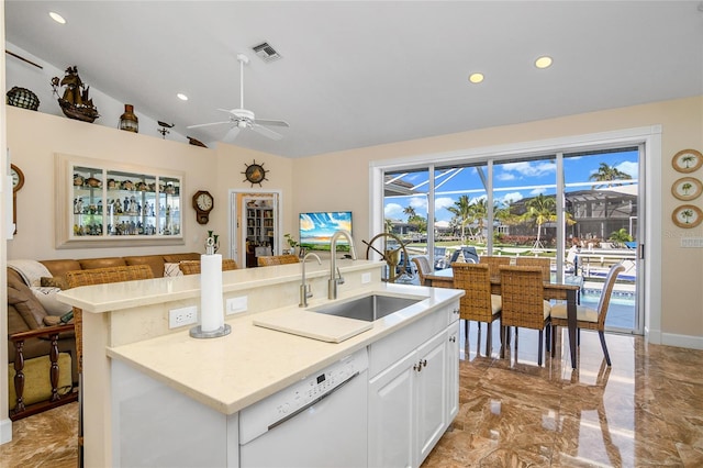 kitchen with white dishwasher, ceiling fan, sink, white cabinets, and lofted ceiling