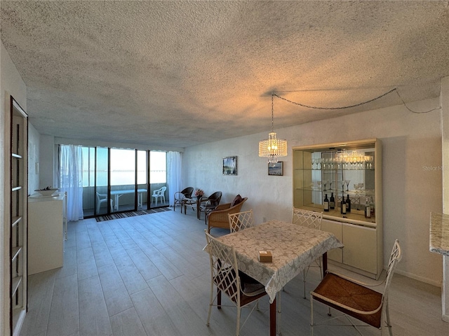 dining room with hardwood / wood-style floors and a textured ceiling