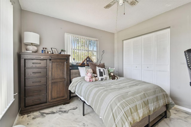 bedroom with ceiling fan, a closet, and a textured ceiling