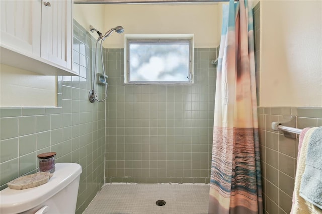 bathroom with a shower with shower curtain, toilet, and tile walls