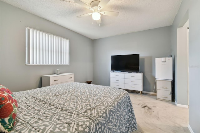 carpeted bedroom with ceiling fan and a textured ceiling