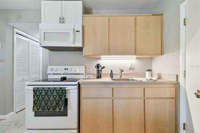 kitchen featuring light brown cabinets, white appliances, and sink