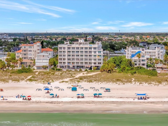 bird's eye view featuring a water view and a beach view