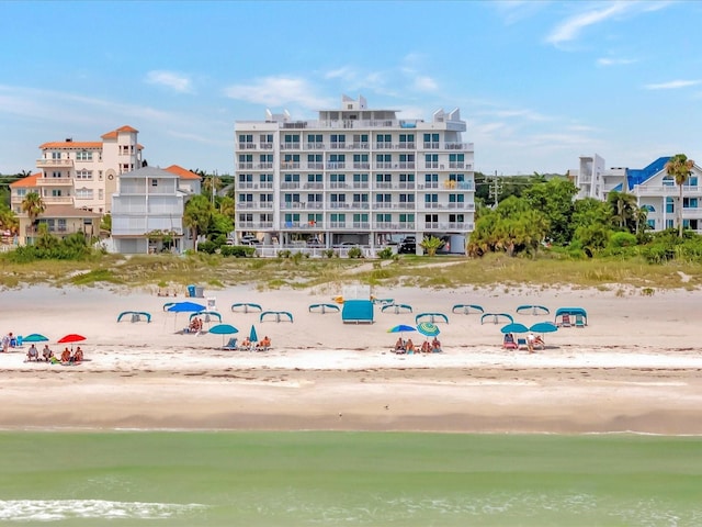 view of property featuring a water view and a view of the beach