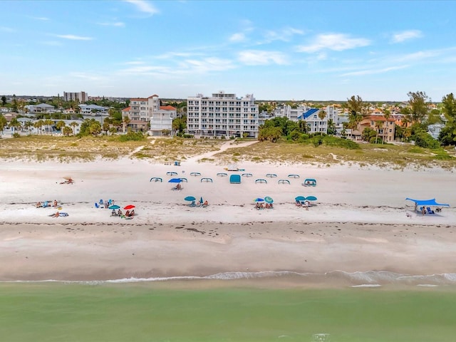 birds eye view of property featuring a water view and a beach view