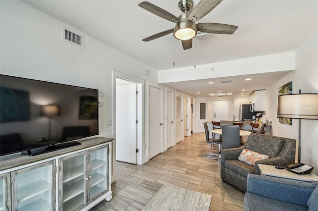 living room with ceiling fan and light hardwood / wood-style floors