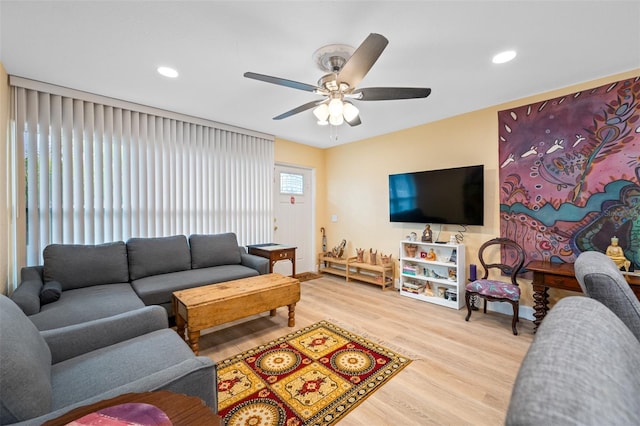 living room featuring ceiling fan and light hardwood / wood-style flooring