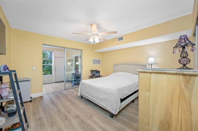 bedroom featuring ceiling fan, a closet, and light hardwood / wood-style flooring