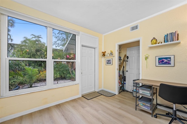 office area with crown molding and light hardwood / wood-style flooring