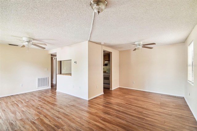 unfurnished room featuring ceiling fan, a textured ceiling, and light hardwood / wood-style flooring