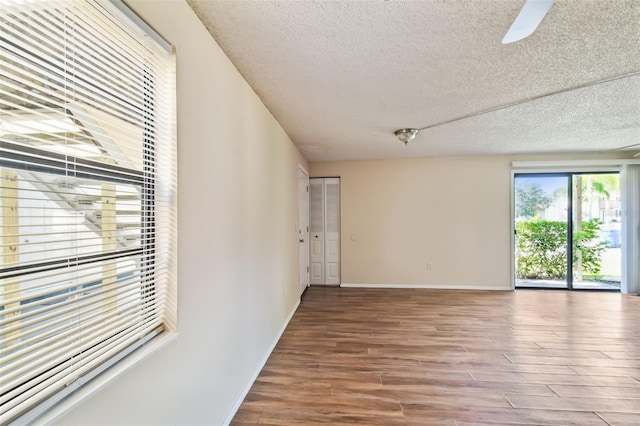 spare room featuring ceiling fan, a textured ceiling, and hardwood / wood-style flooring