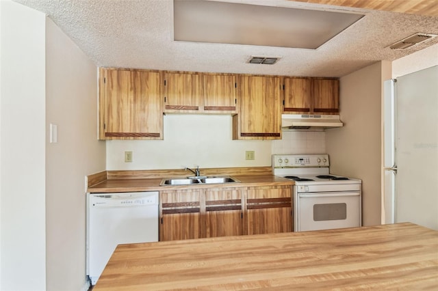 kitchen with a textured ceiling, tasteful backsplash, sink, and white appliances