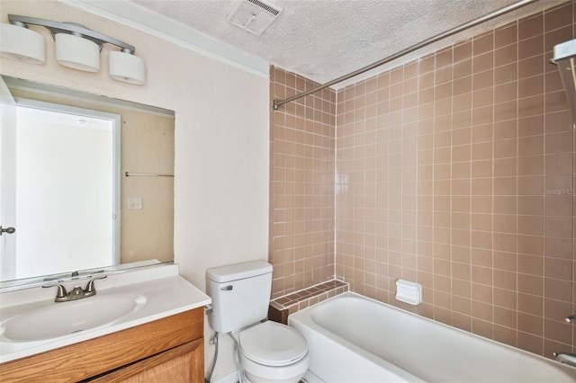 full bathroom with vanity, toilet, a textured ceiling, and tiled shower / bath