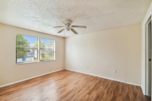 unfurnished room with wood-type flooring and a textured ceiling