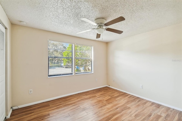 spare room featuring ceiling fan, a textured ceiling, and light wood-type flooring