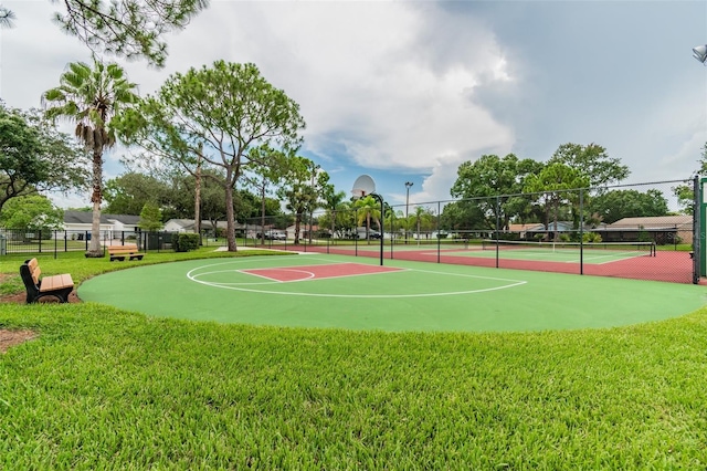 view of sport court with a lawn and tennis court