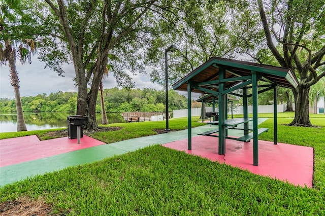 view of community with a gazebo, a water view, and a lawn