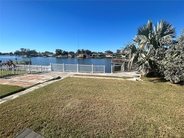 dock area featuring a yard and a water view