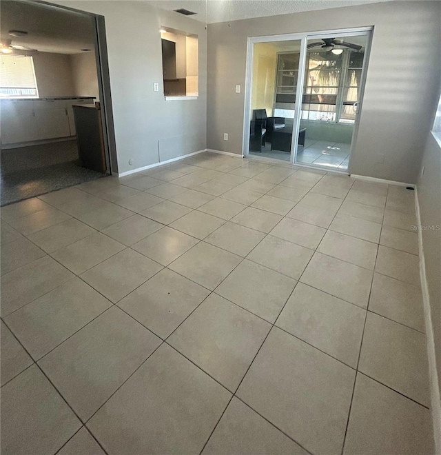 unfurnished room featuring ceiling fan and light tile patterned floors