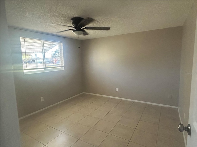 tiled empty room with a textured ceiling and ceiling fan