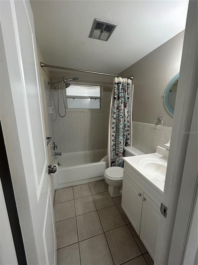 full bathroom with tile patterned floors, vanity, toilet, and shower / tub combo with curtain