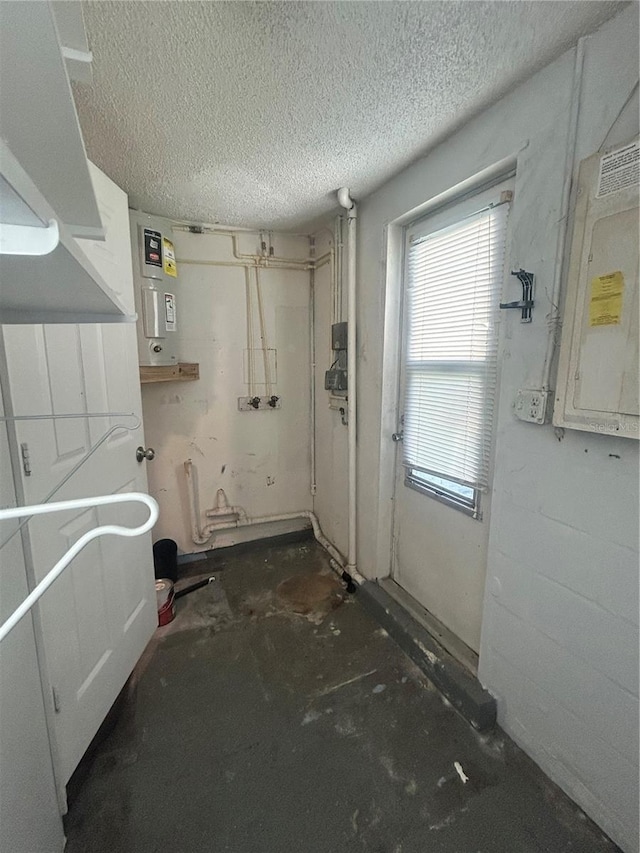 bathroom featuring electric panel, water heater, concrete flooring, and a textured ceiling