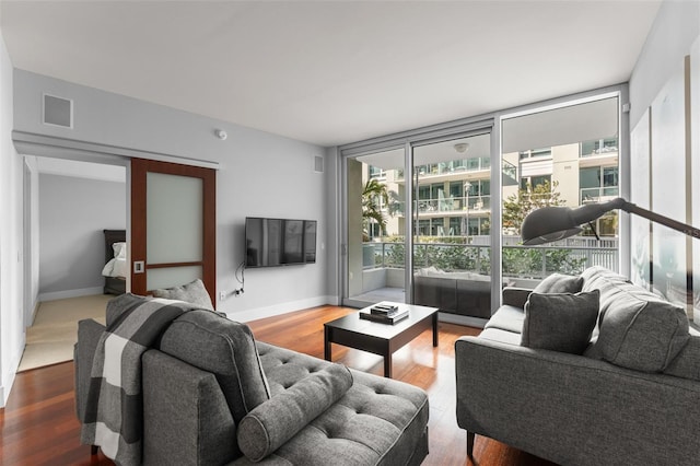 912 Channelside Dr Unit 2320, Tampa, FL 33602 - living room with a wall of windows, wood finished floors, and baseboards