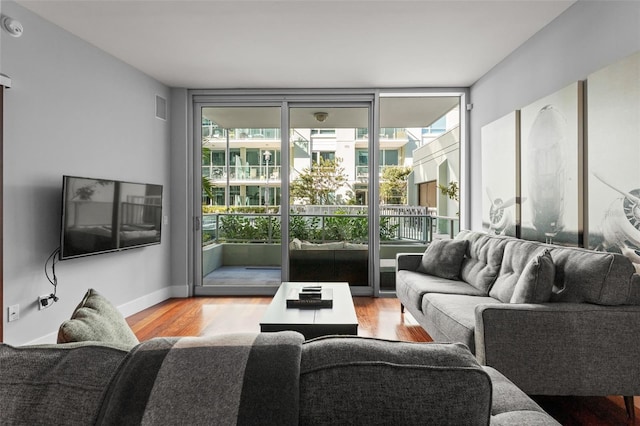 912 Channelside Dr Unit 2320, Tampa, FL 33602 - living room featuring wood finished floors, floor to ceiling windows, and baseboards