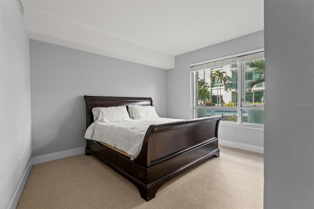 bedroom featuring light colored carpet