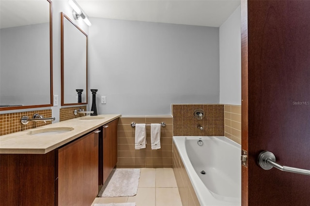 bathroom featuring tile patterned flooring, vanity, and a bath