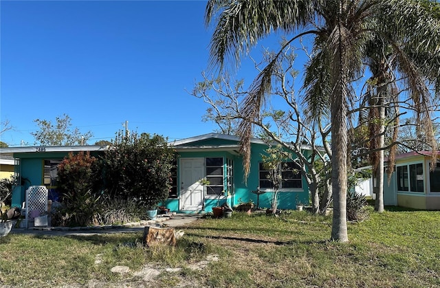 back of property featuring a lawn