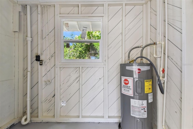 utility room featuring water heater