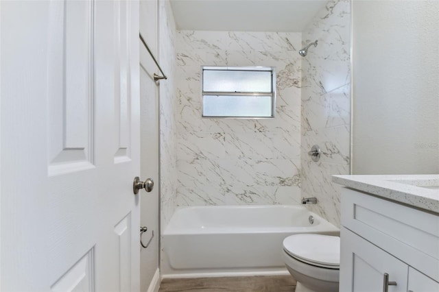 full bathroom with vanity, toilet, and tiled shower / bath combo