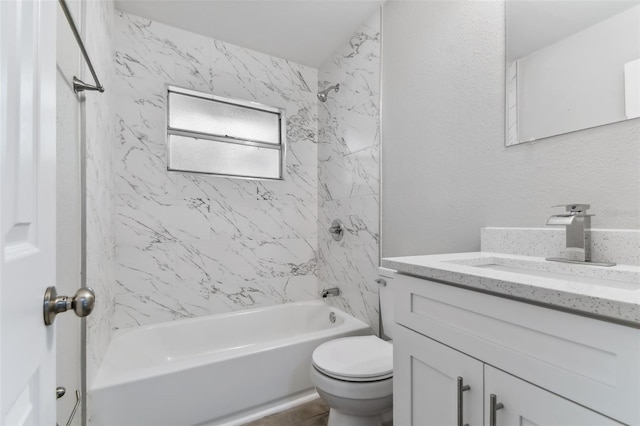 full bathroom with toilet, vanity, and tiled shower / bath