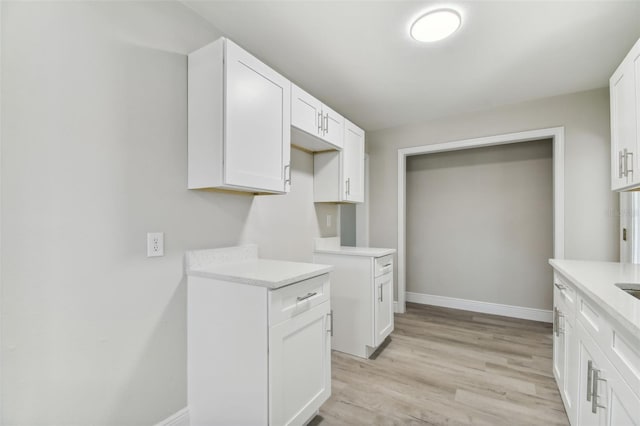 kitchen with white cabinets and light hardwood / wood-style floors