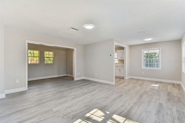 unfurnished living room featuring light hardwood / wood-style flooring