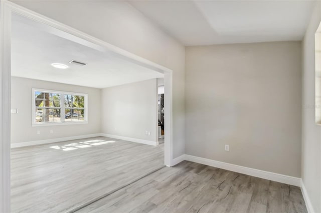 unfurnished room with light hardwood / wood-style floors